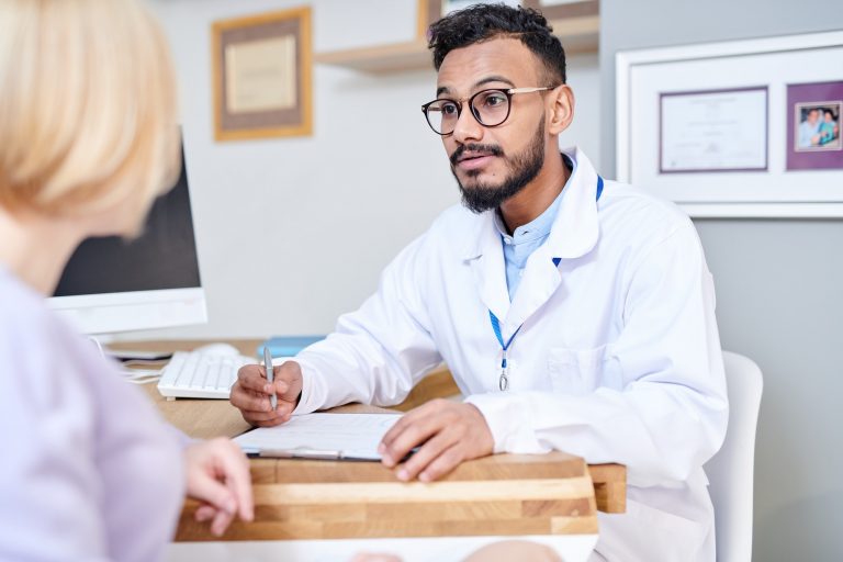 Middle-Eastern Doctor Consulting Female Patient
